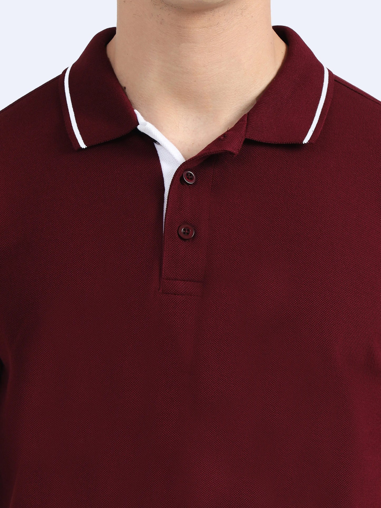Maroon polo shirt with white collar stripe, button placket, and textured fabric