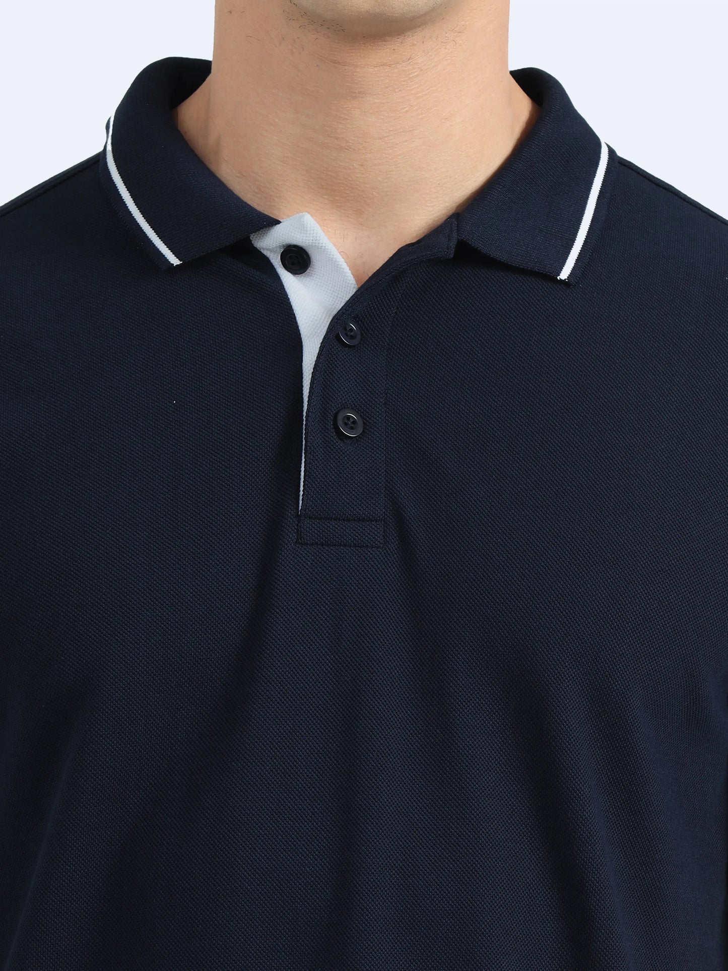 Close-up of a navy blue polo shirt with white collar trim and button placket, ideal for corporate uniforms.