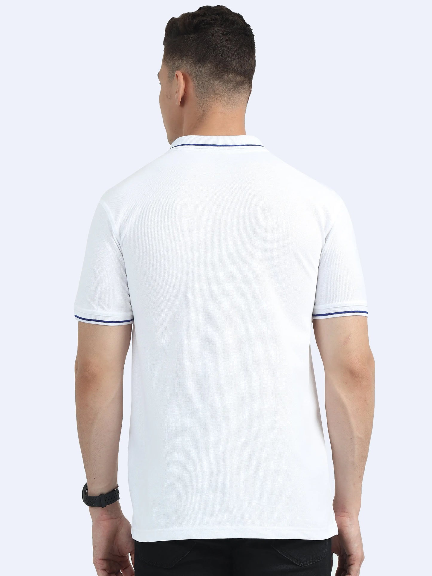 Back view of a man wearing a white short-sleeve polo shirt with navy trim