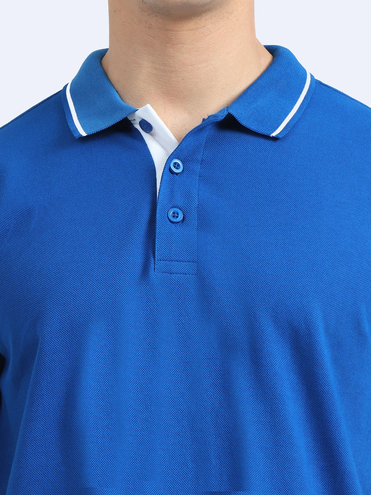 Close-up of a blue polo shirt with a white-tipped collar and button placket, ideal for corporate wear.