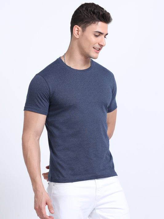 Man wearing plain navy blue t-shirt and white pants, perfect for promotional apparel