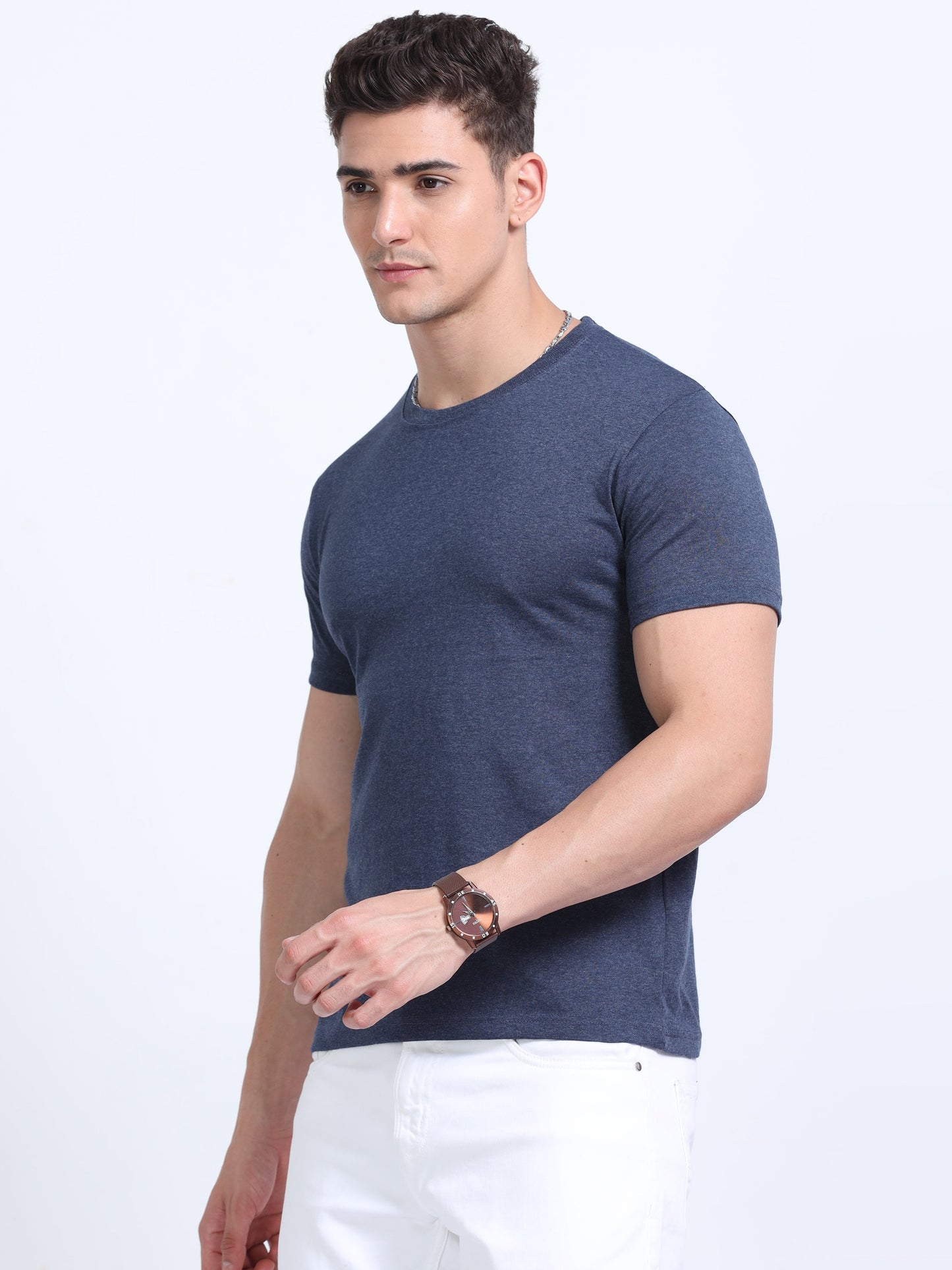 Man wearing a navy blue crew neck t-shirt and white pants, ideal for corporate gifting and promotional apparel