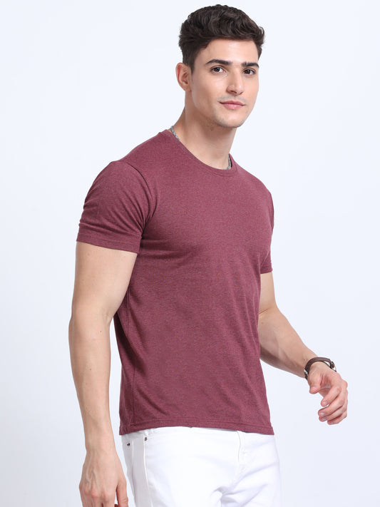 Man wearing maroon crew neck t-shirt and white pants, corporate casual apparel