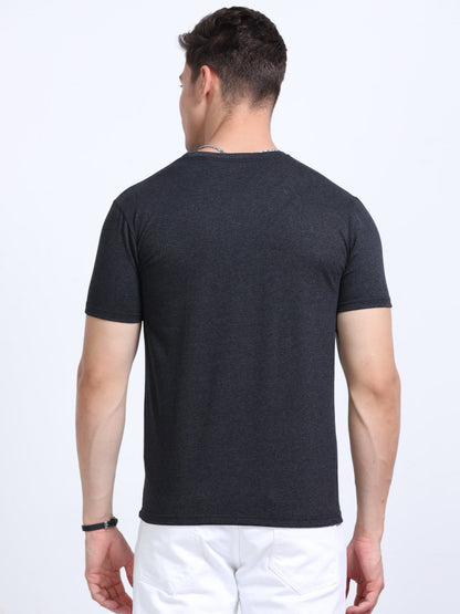 Back view of man wearing a plain black short sleeve t-shirt and white pants