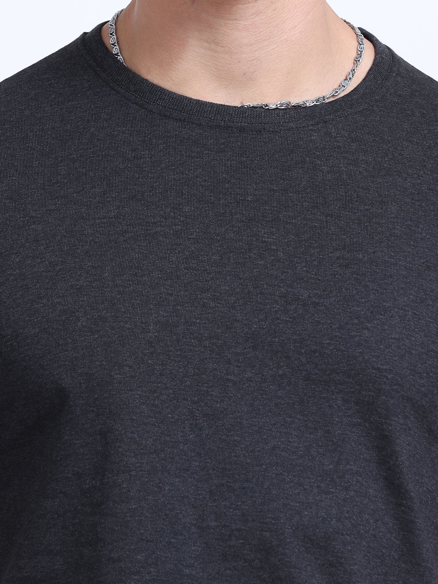 Close-up of a plain black crew neck t-shirt, ideal for corporate branding and customization