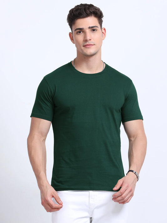 Man wearing plain green crew neck t-shirt and white pants, bulk team apparel